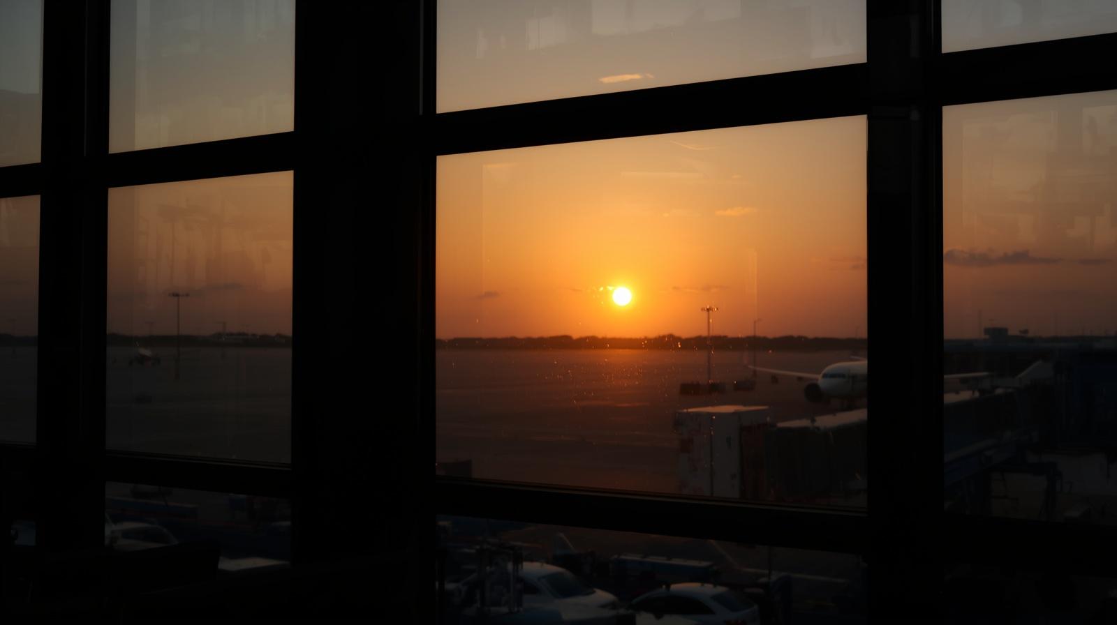 sunrise through airport window symbolizing long distance relationship